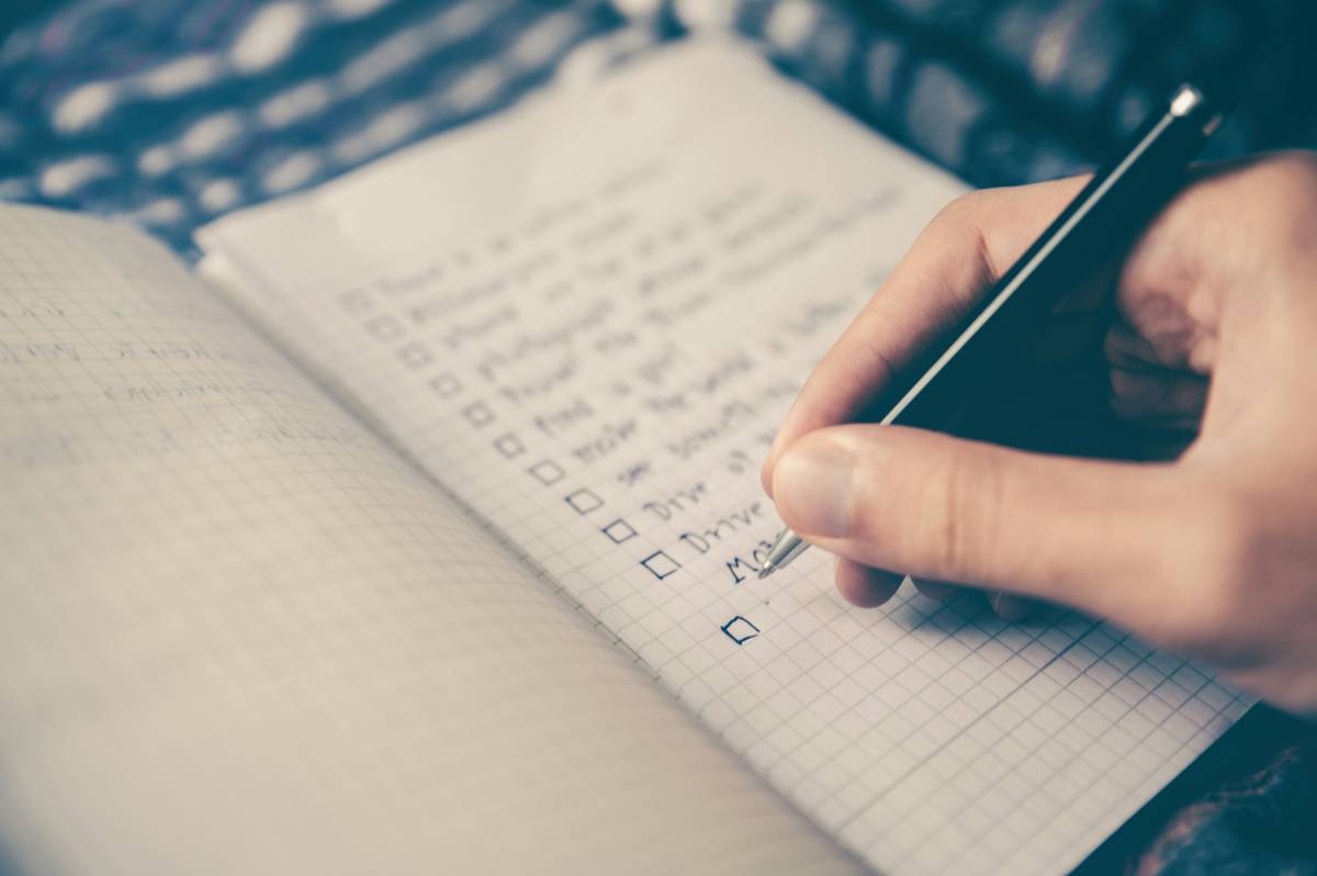 Goal Monitoring Plans illustrated with journal, scale, water bottle, and weekly checklist on wooden table