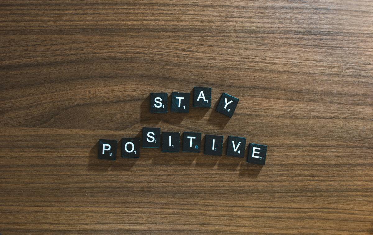 Woman journaling with smile, practicing Positive Thinking during weight loss journey