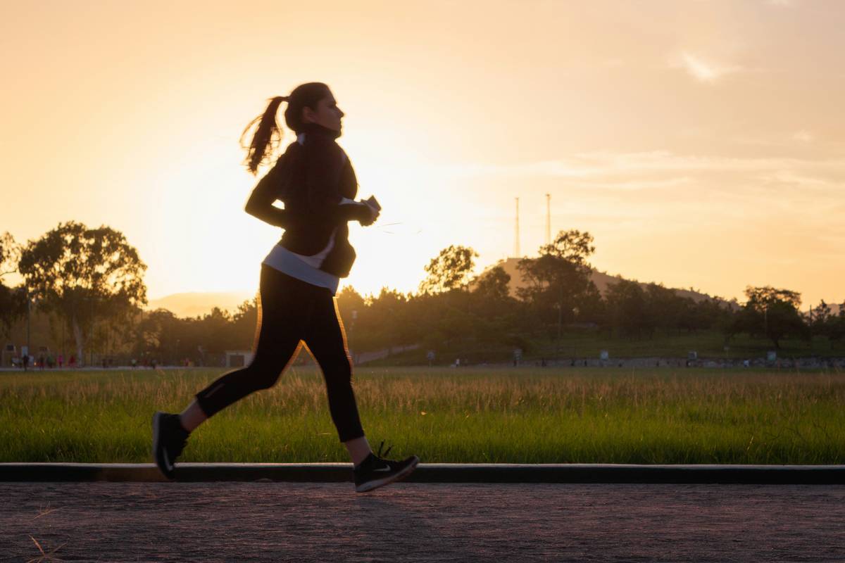 Woman journaling fitness plan to Achieve Your Goals